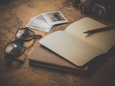 map, notebook, and glasses on the table